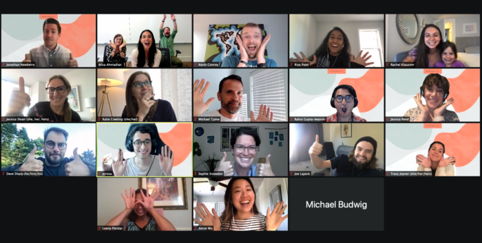 18 squares of smiling teammates waving and looking sharp on the Zoom call.